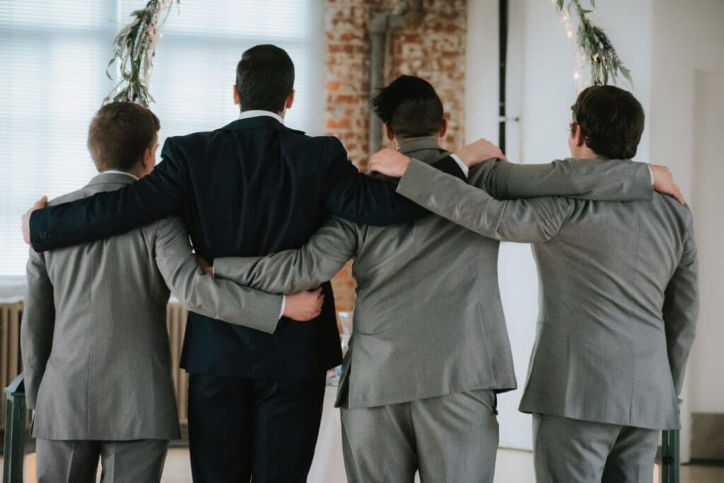 FOUR YOUNG MEN IN SUITS