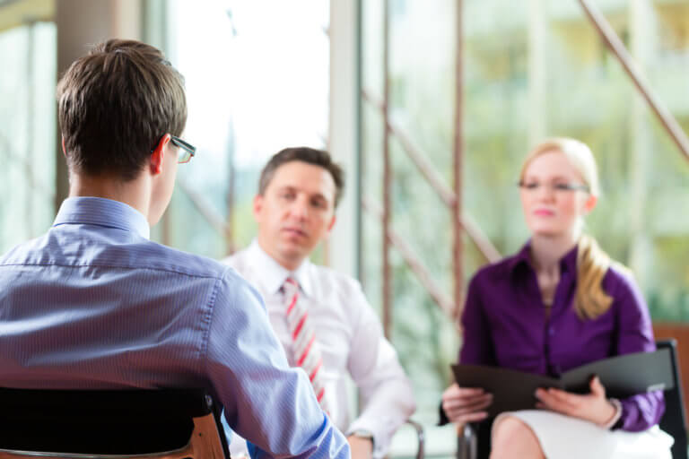 Man being interviewed by two recruitment specialists. RPO concept.