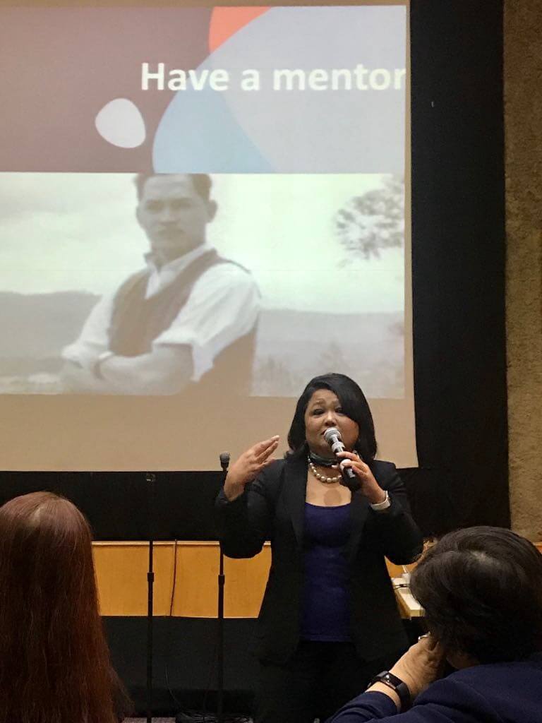 A female executive giving best career tips to an audience.