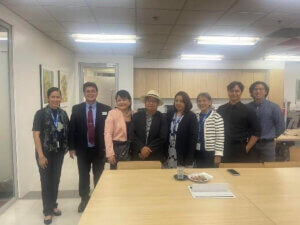 small group of people posing for a photo in a conference room 