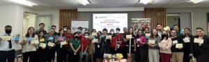 big group of people posing for a photo holding up certificates 