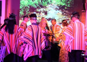 small group lit in colorful lighting and performing a dance