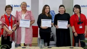 five women posing and holding up certificates for a photo 