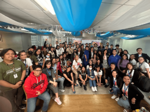 big group of people posing for photo indoor