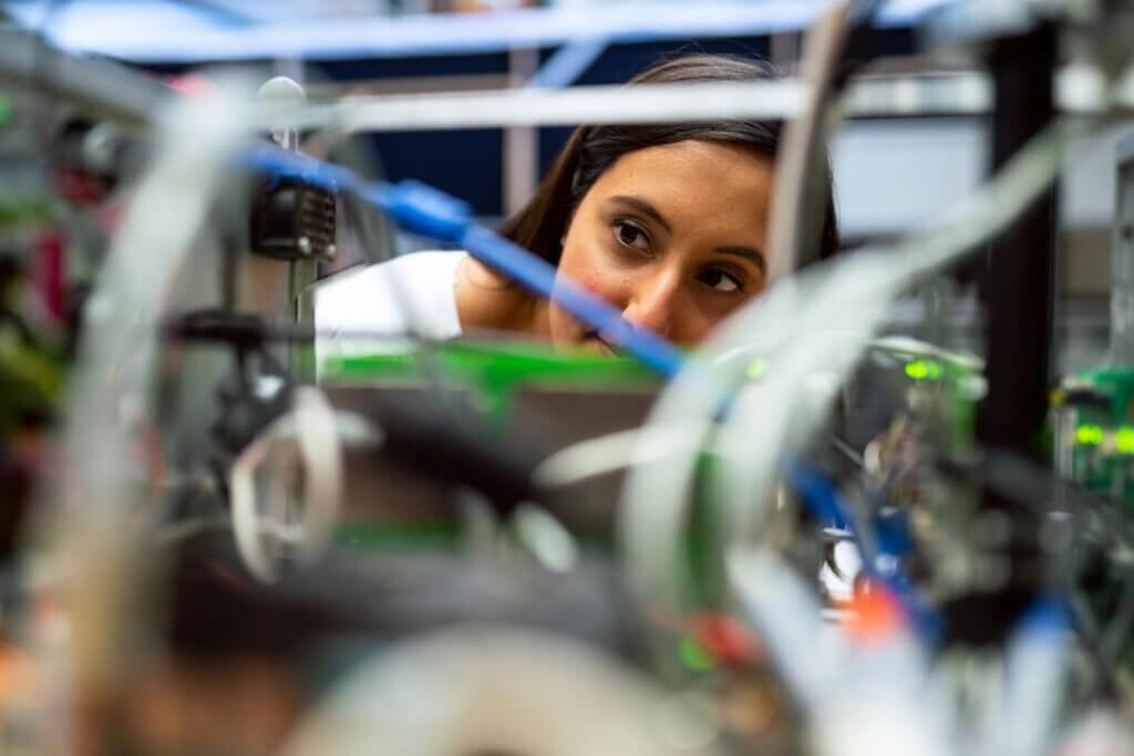 Woman looking through wires