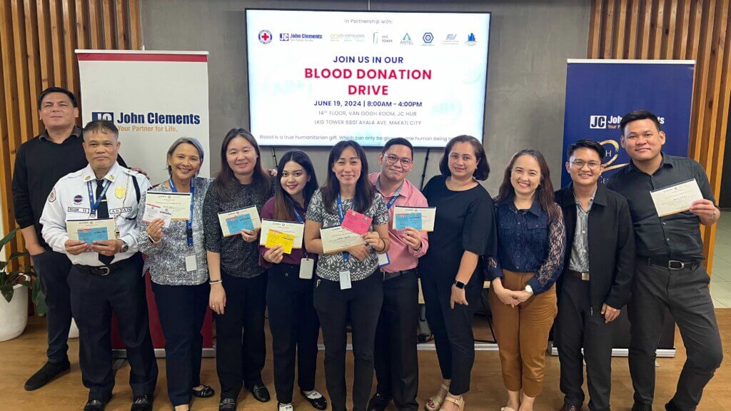 donors holding their certificates at John Clements Blood Drive