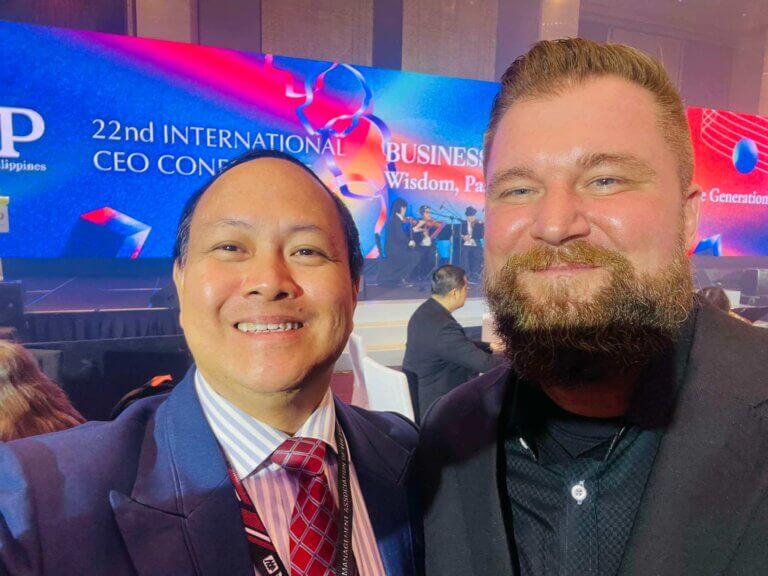 two men smiling for a photo during a session on generative AI