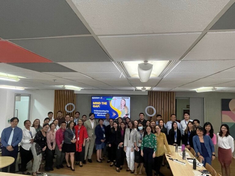 Group photo of attendees during a session on mental health in the workplace.