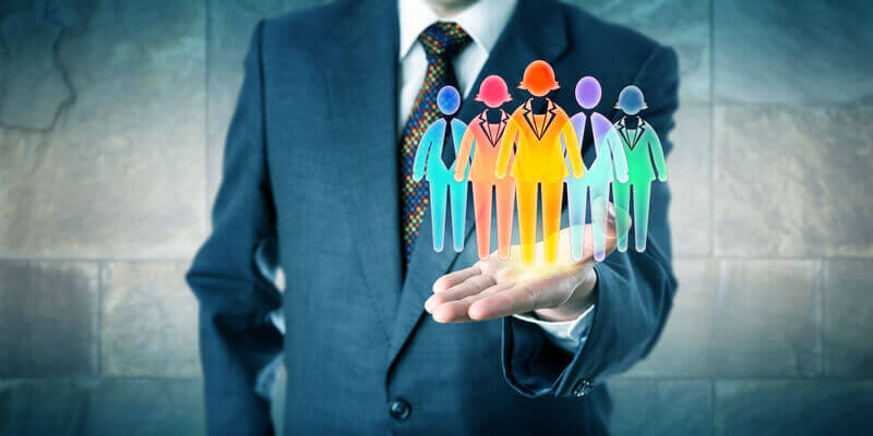 Businessman showcasing diverse figures in his hand, symbolizing effective diversity recruitment strategies in the workplace.