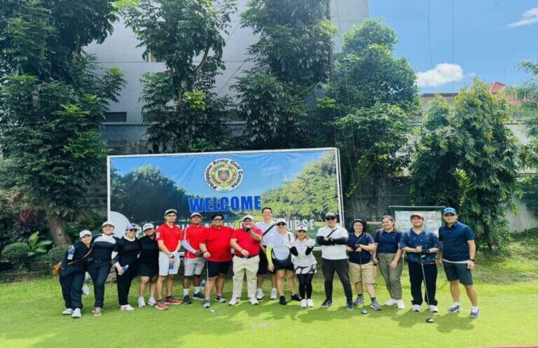 Participants of the 2nd JCCI-EDI Golf Tournament pose for a photo in front of a banner.