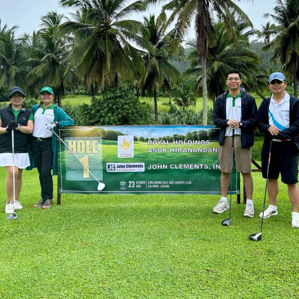 Participants at the PGH Charity Golf Tournament pose at Hole 1 on a lush, green course at Canlubang Golf and Country Club.