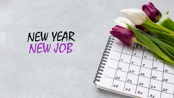 A spiral calendar with a bouquet of purple and white tulips placed on top, accompanied by the text "NEW YEAR, NEW JOB," symbolizing the transition to a new job and fresh beginnings.