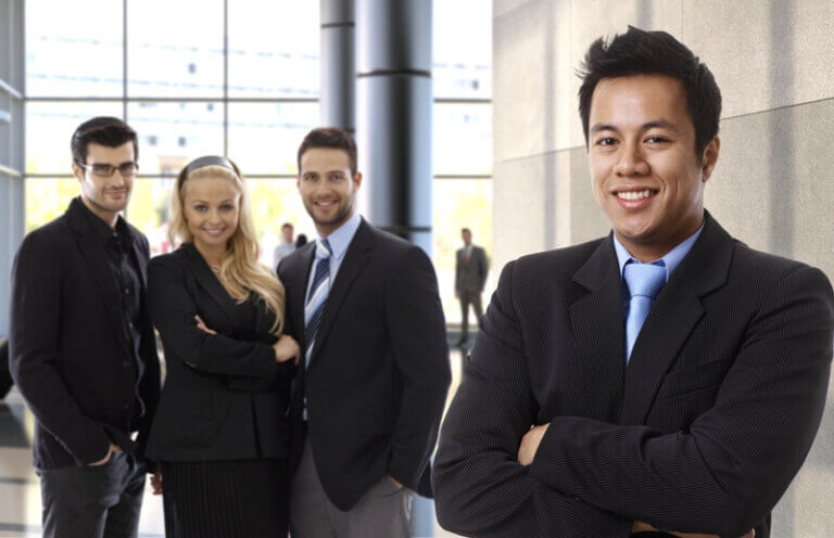 Confident business executives in a modern office, representing executive job opportunities and professional career growth.