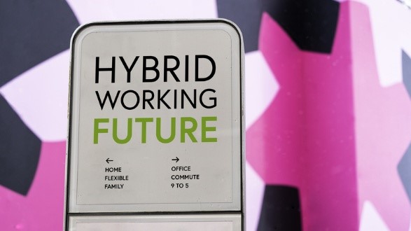 Signpost illustrating the hybrid work model with arrows pointing to flexible home-based work and traditional office-based work.