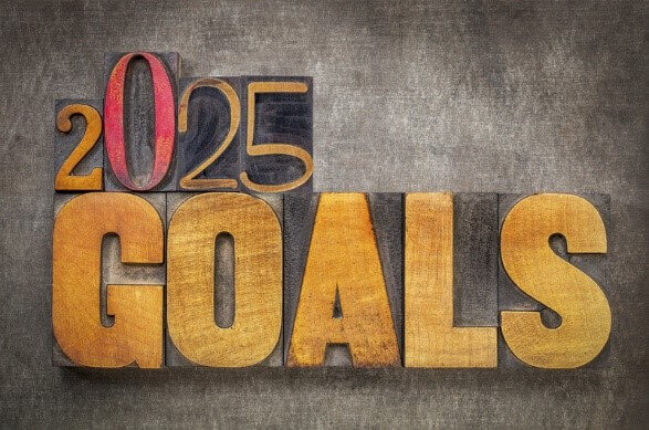 2025 Goals text in bold wooden letters, symbolizing resilient career goals and determination for future success.