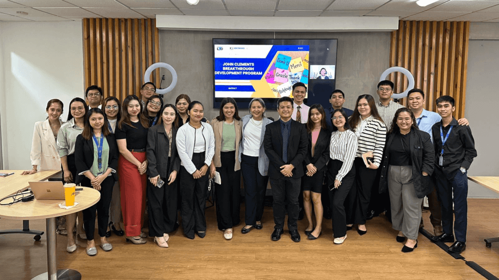 A group of professionals posing together at the John Clements Breakthrough Development Program, an employee development program designed to enhance leadership and professional growth.