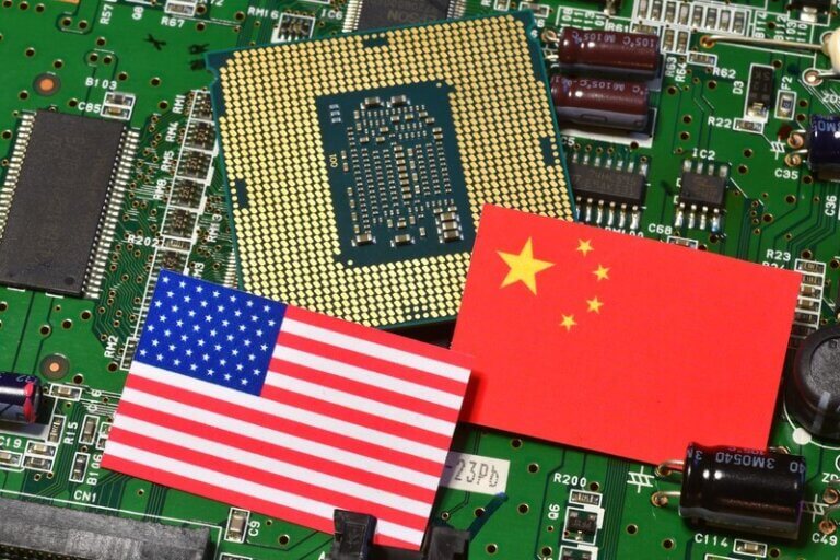 A semiconductor chip placed on a circuit board, with the flags of the United States and China, symbolizing the global semiconductor industry and geopolitical competition in technology.