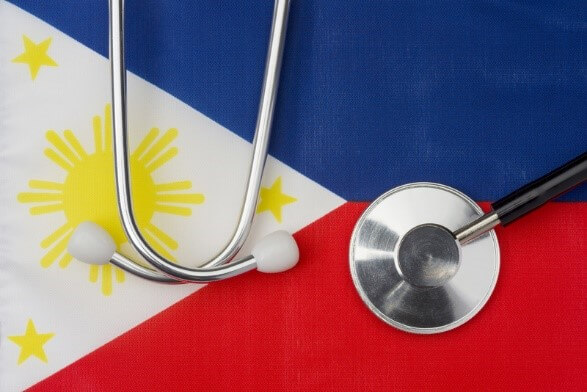 A stethoscope placed on the Philippine flag, symbolizing healthcare and PhilHealth updates for 2025.