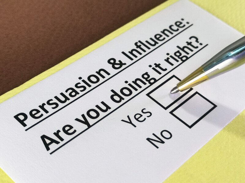 A survey-style form with the title "Persuasion & Influence: Are you doing it right?" and checkboxes for "Yes" and "No," with a pen pointing at the options.