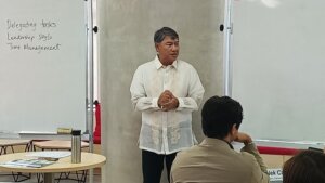 A speaker in a Barong Tagalog discusses effective delegation in leadership, focusing on delegating tasks, leadership styles, and time management.