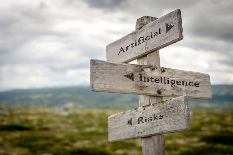 Wooden signpost pointing to "Artificial," "Intelligence," and "Risks," symbolizing the challenge of AI misinformation.