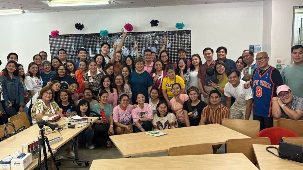 A diverse group of professionals in a casual office setting celebrating career milestones, representing nontraditional career paths in the Philippines.