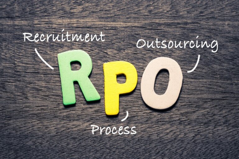 Colorful letters "RPO" on a wooden surface with the words "Recruitment Process Outsourcing" written around them.