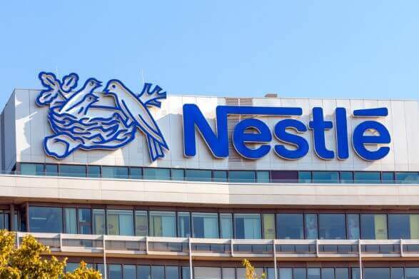 Nestlé headquarters with logo displayed on the building, representing the company's commitment to sustainable food innovation.