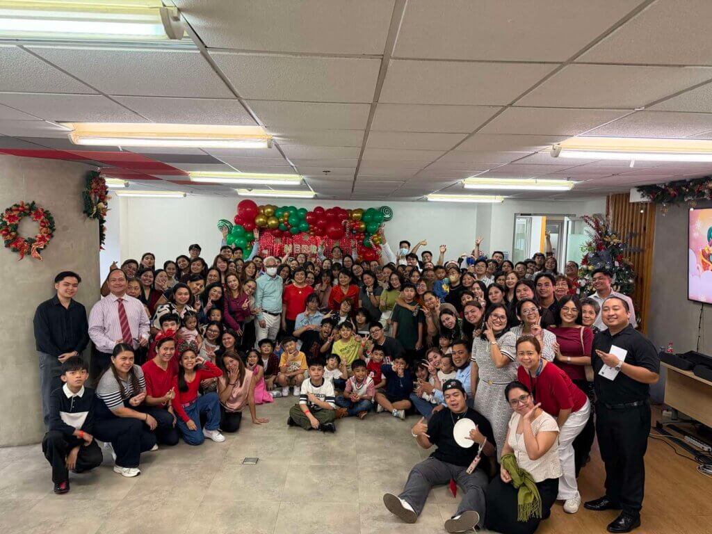 Corporate Christmas potluck celebration with employees sharing home-cooked dishes and festive cheer
