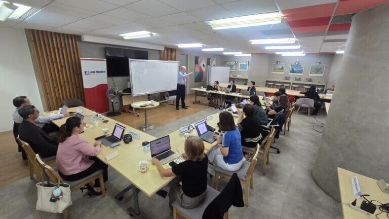 Participants facilitating a case study discussion on a whiteboard